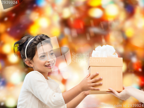 Image of smiling little girl with gift box