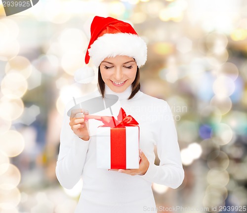 Image of smiling woman in santa helper hat with gift box