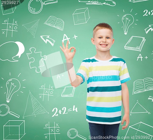 Image of little boy in casual clothes making OK gesture