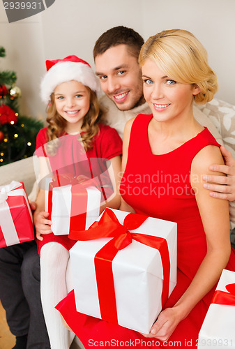Image of smiling family holding many gift boxes