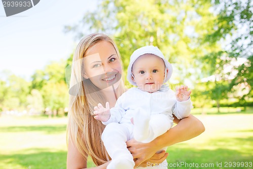 Image of happy mother with little baby in park