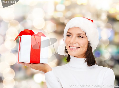 Image of smiling woman in santa helper hat with gift box