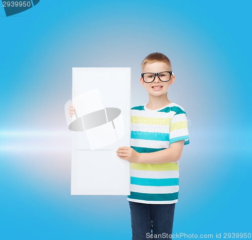 Image of smiling boy in eyeglasses with white blank board