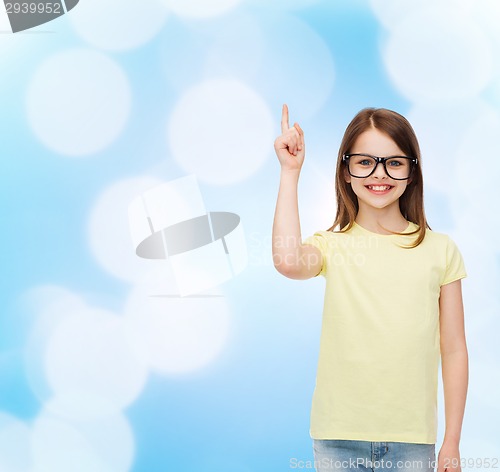 Image of smiling cute little girl in black eyeglasses