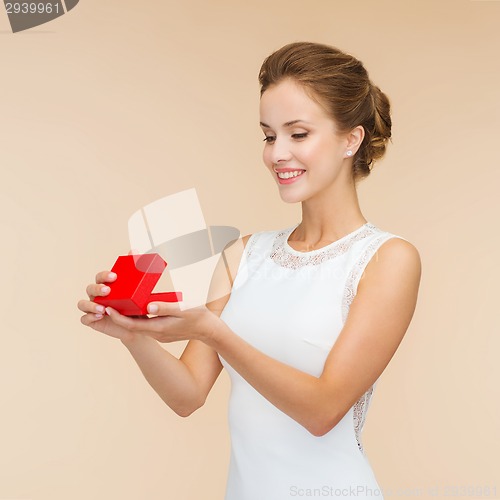 Image of smiling woman holding red gift box