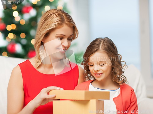 Image of happy mother and child girl with gift box