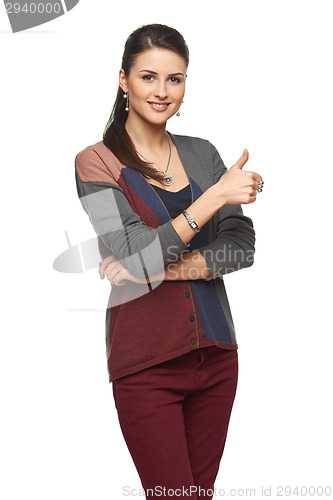 Image of Gorgeous young brunette showing big thumbs up on white background.