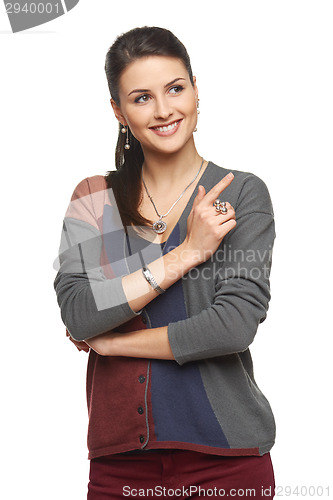 Image of Woman in cardigan pointing at blank copy space