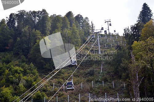 Image of Closed chair lifts moving along the slope