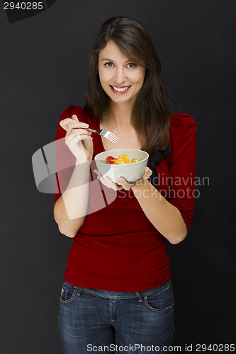 Image of Young woman eating an apple