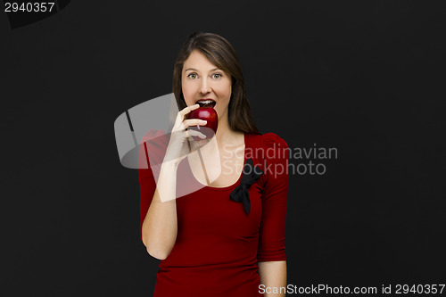 Image of Young woman eating an apple