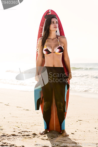 Image of Surfer girl with her surfboard