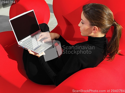 Image of woman using laptop at home a