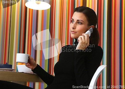 Image of Woman with Coffee and Cell Phone
