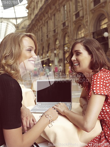 Image of happy businesswomen with laptop