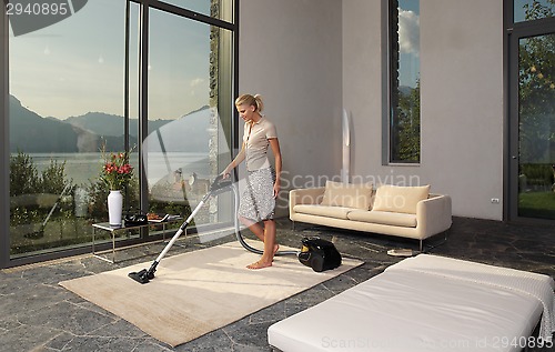 Image of housewife with vacuum cleaner