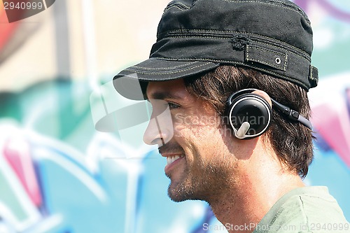 Image of guy listening to player in earphones e