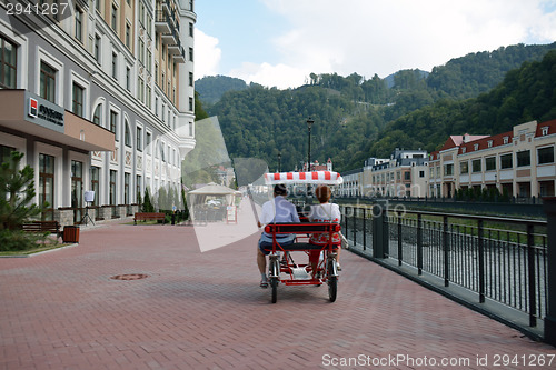 Image of Two people riding in a car-bike in Krasnaya Polian