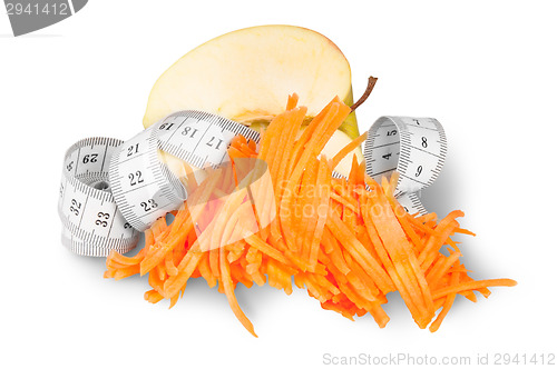 Image of Half An Apple With Grated Carrots And Sewing Measuring