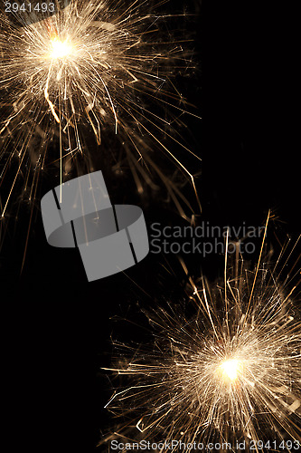 Image of Burning sparklers on black background