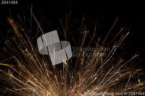 Image of Closeup of a sparkler on black background