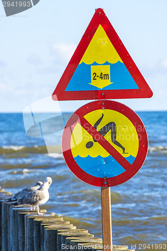 Image of Groin in the Baltic Sea with danger sign