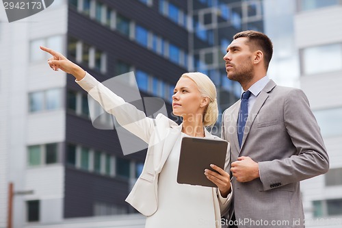 Image of serious businessmen with tablet pc outdoors