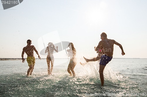 Image of happy friends having fun on summer beach