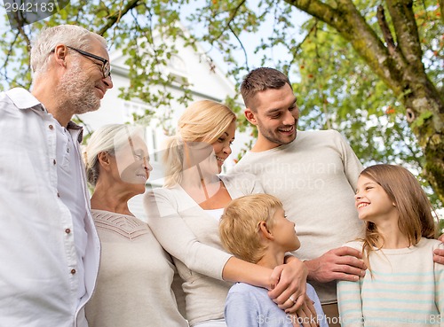 Image of happy family in front of house outdoors