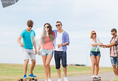 Image of group of smiling teenagers with skateboards