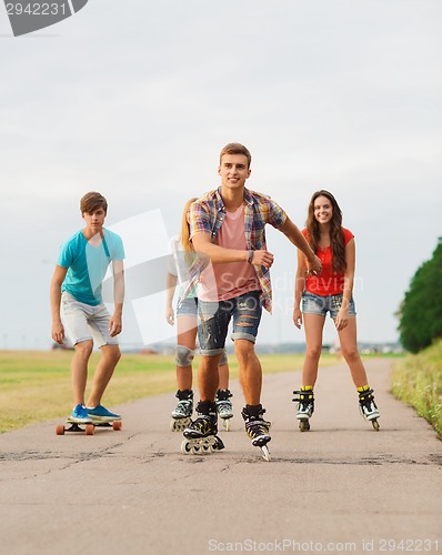 Image of group of smiling teenagers with roller-skates