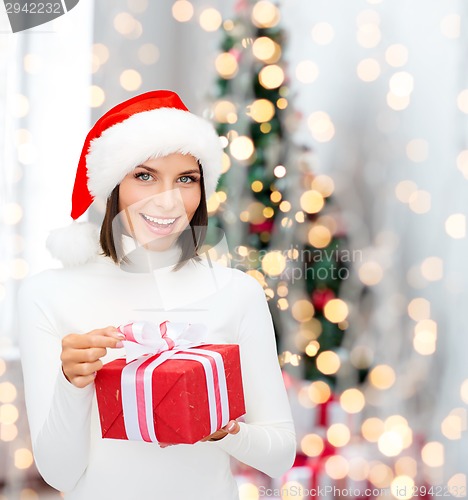 Image of smiling woman in santa helper hat with gift box