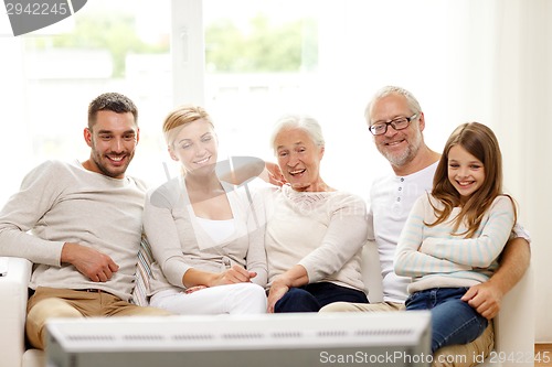 Image of happy family watching tv at home