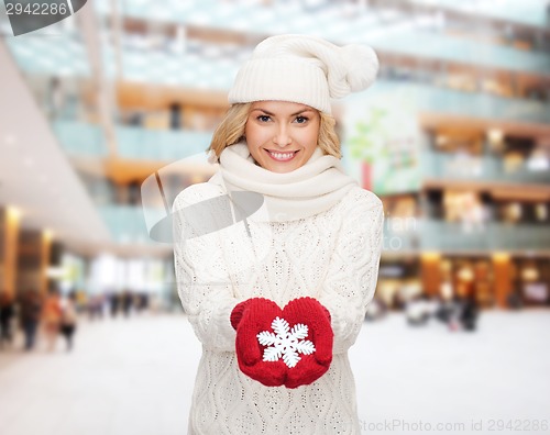 Image of smiling woman in winter clothes with snowflake