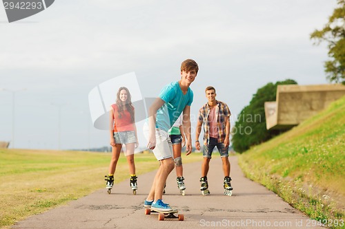 Image of group of smiling teenagers with roller-skates