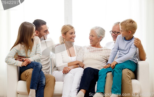 Image of happy family sitting on couch at home