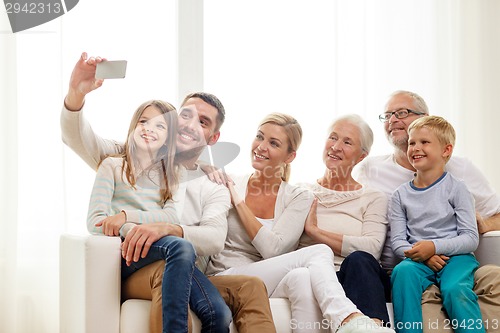 Image of happy family with smartphone at home