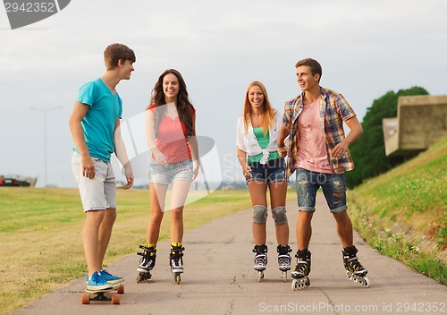 Image of group of smiling teenagers with roller-skates