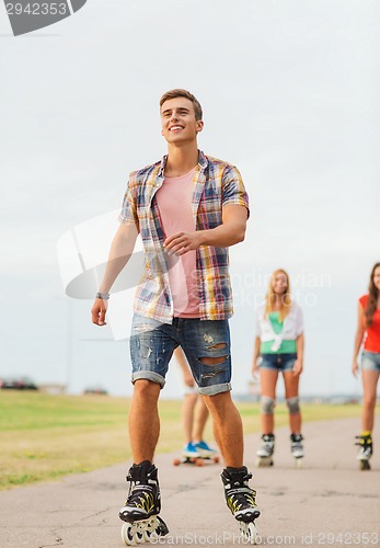 Image of group of smiling teenagers with roller-skates