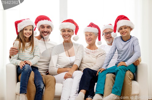 Image of happy family sitting on couch at home