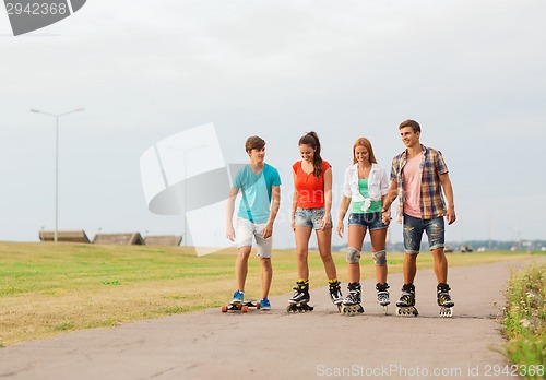Image of group of smiling teenagers with roller-skates