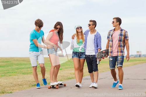 Image of group of smiling teenagers with skateboards