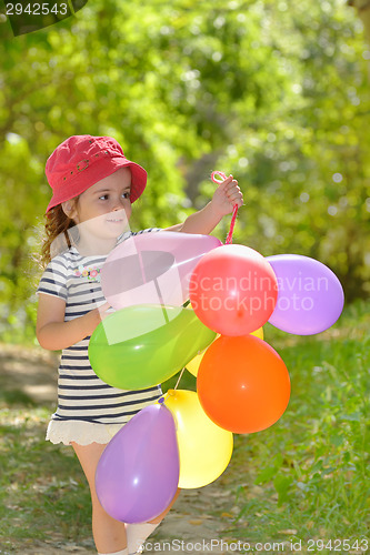 Image of girl plays in summer park 