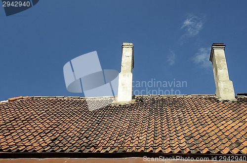 Image of old tile roof on blue sky