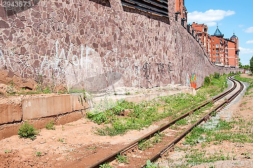 Image of The rails of the railway and the facade of the building
