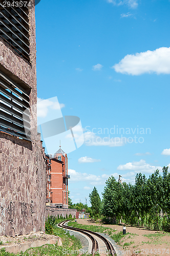 Image of The rails of the railway and the facade of the building
