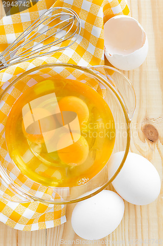 Image of Raw eggs and whisk