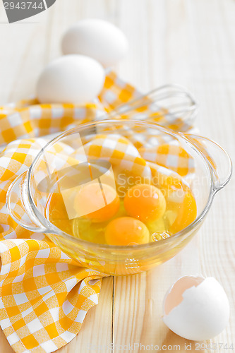 Image of Raw eggs and whisk