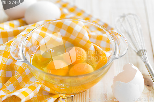 Image of Raw eggs and whisk