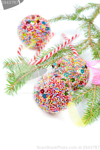 Image of Green spruce with Christmas balls and candy canes